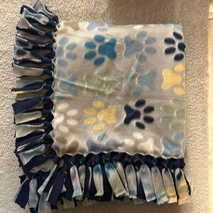 50x60” fleece tie blanket. Puppy paw pattern fleece - dark blue fleece backing